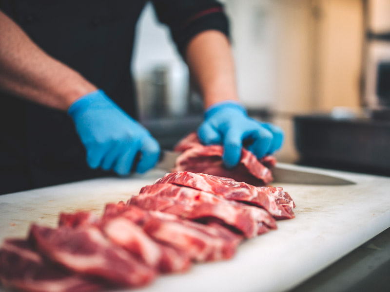 butcher cutting meat